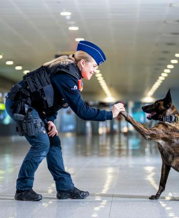  Inspektorin mit Polizeihund im Flughafen